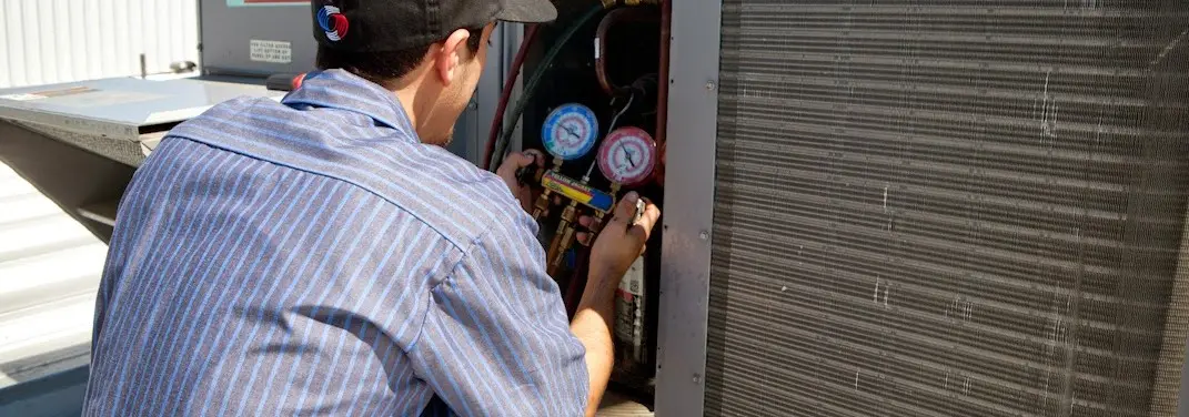 HVAC technician servicing a condenser unit in White Settlement