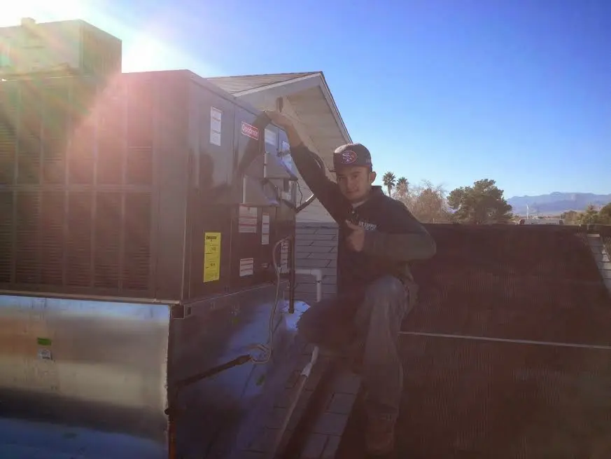 HVAC technician performing Boiler Repair on a rooftop unit in White Settlement